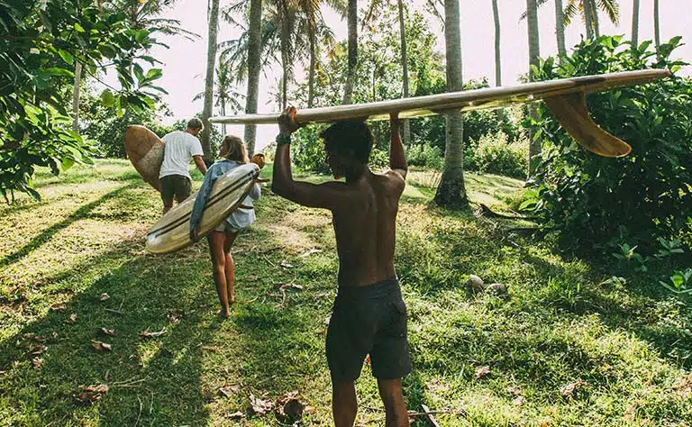 Surfer riding a wave at Uluwatu Beach in Bali