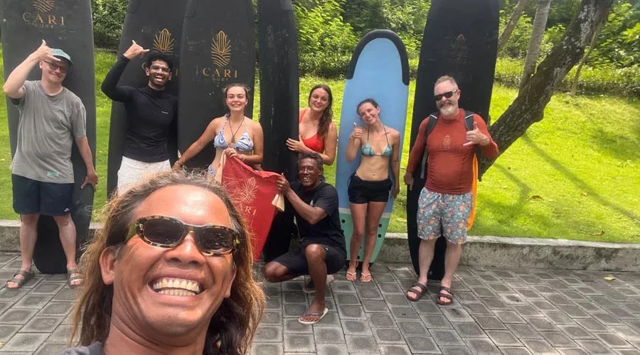 Happy CARI Surf Camp guests with a surf coach in Bali
