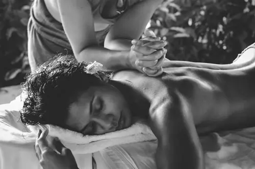 a woman getting a relaxing massage at Cari Surf Camp in Bali after a surf lesson.