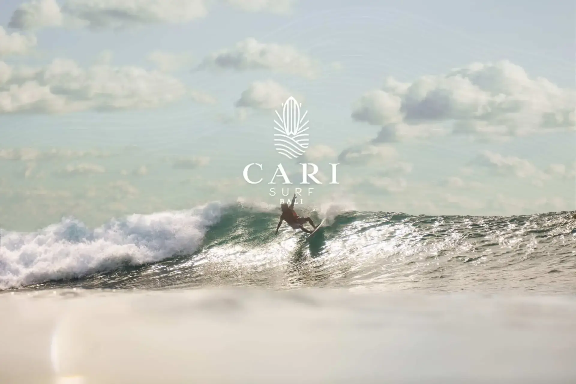 Surfer riding a wave at CARI Surf Camp in Uluwatu