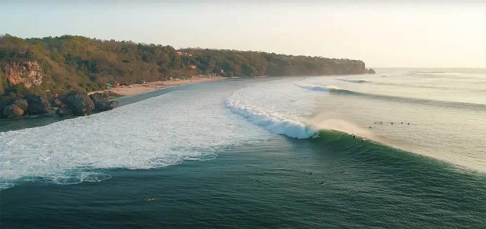Surfer riding a wave at Uluwatu, Bali